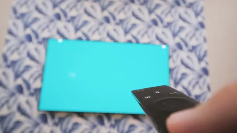 A person using modern OLED TV with remote control. Stock Footage 170008733