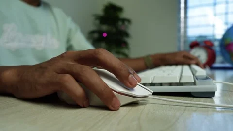 Person Using Mouse and Keyboard at Home Office, Close-up of a person using .. Video stock 345119234