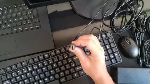 A person using multiple computer keyboards and mouse in a video Stock Footage 340200929