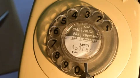 Person using old style rotary dial telephone Stock Footage 58810504