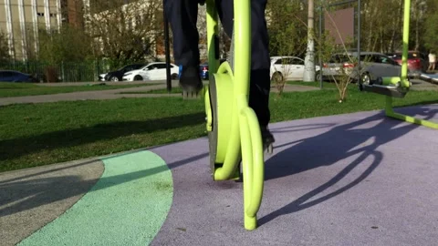 A person using outdoor exercise equipment in a park. Stock Footage 312642095