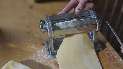 A person is using a pasta maker to make pasta Stock Footage 305983408