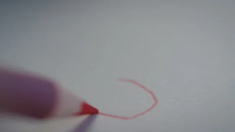 Person using a pencil to draw a heart on a piece of paper Stock Footage 274589012
