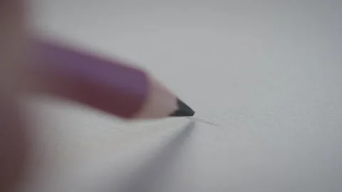 Person using a pencil to draw on paper Stock Footage 274590411