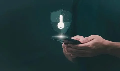 Person using phone with digital security shield icon Stock Photos