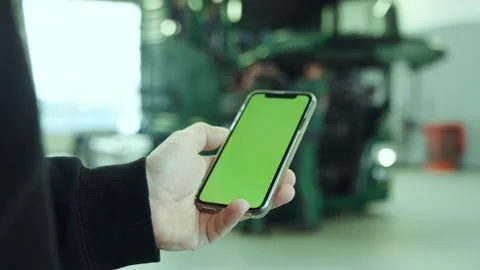 Person using a phone with green screen in front of a truck Stock Footage 132730155