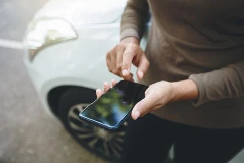 Person using phone on road Foto stock