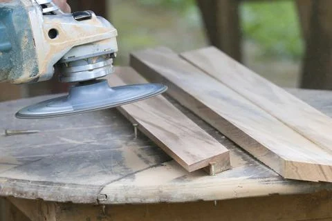 A person is using a power tool to cut wood Stock Photos