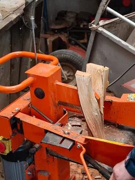 Person using a powerful hydraulic log splitter Stock Photos