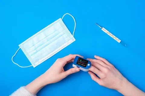 Person using pulse oximeter device on finger Stock Photos