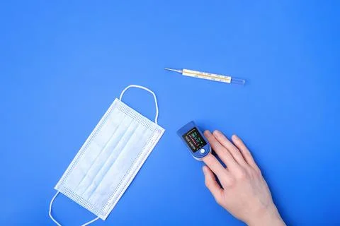 Person using pulse oximeter device on finger Stock Photos