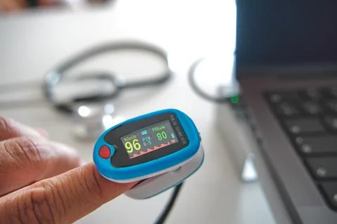 Person using pulse oximeter for remote health monitoring Stock Photos