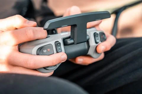 Person using a remote control for a dji drone 写真素材