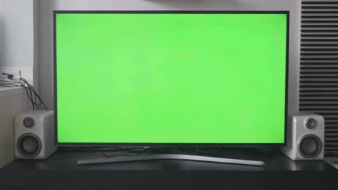 Person using remote control with green screen television Stock Footage 334137045