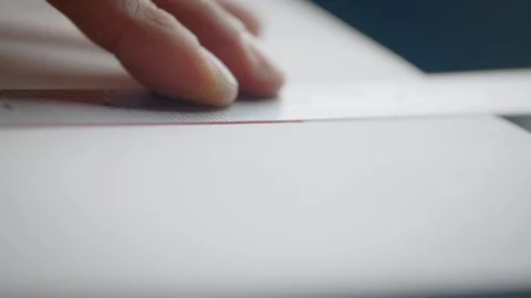 Person using a ruler to draw a straight line on a piece of paper Stock Footage 274584189