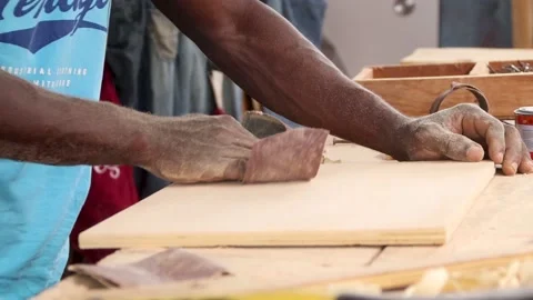 Person using sandpaper to smoothen surface of a wood. Carpentry works.	 Stock Footage 223790972