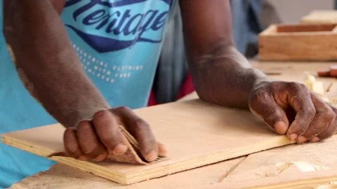 Person using sandpaper to smoothen surface of a wood. Carpentry works. Stock Footage 223791483
