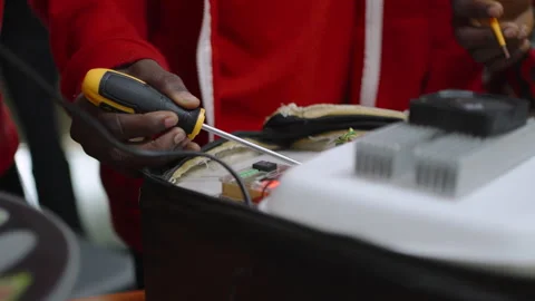 Person using a screwdriver inside an open electronic device Video stock 347937387