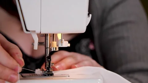 Person using a sewing machine to hem fabric Stock Footage 149444513