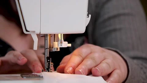 Person using a sewing machine to hem fabric Stock Footage 149444592