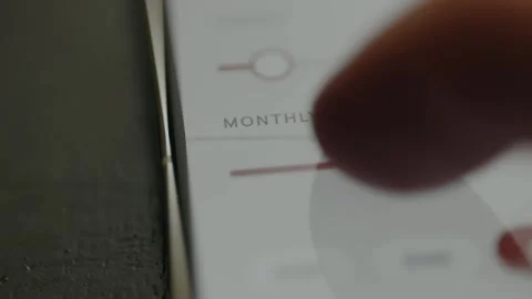 Person using a slider to set a Monthly amount of money Stock Footage 332492164