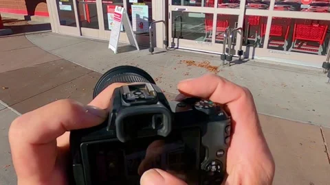 A person using an SLR Canon Camera Stock Footage 143446008