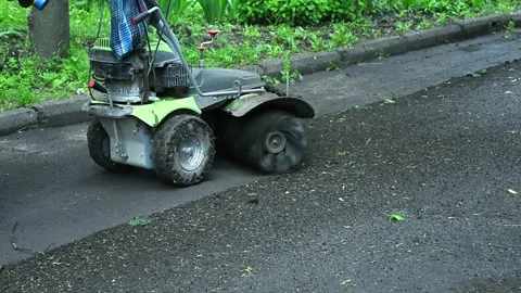 Person using small road cleaning vehicle Stock Footage 335387280