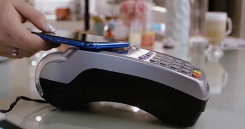 Person using smart phone as paying device with nfc technology POS device EMV Video stock 336585652