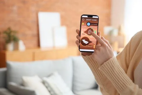 Person using smartphone app to control smart home security system Stock Photos