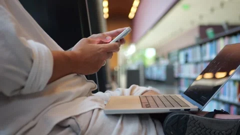 Person Using Smartphone Beside Laptop in Modern Workspace... Video stock 334436973