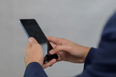 Person Using Smartphone with Blurred Background and Focused Hands 스톡 사진