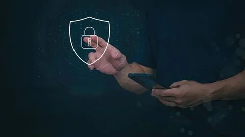Person using smartphone with digital security shield icon Stock Photos