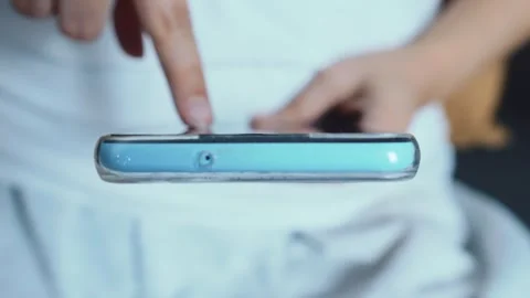 Person using a smartphone with a finger pointing at the touch screen, Stock Footage 335146788