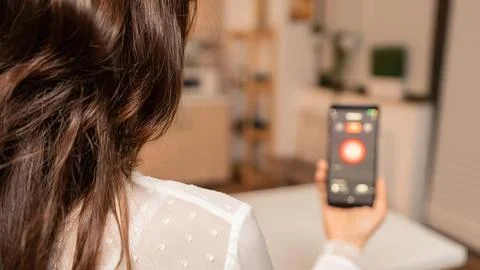 Person using smartphone flashlight at home Stock Photos