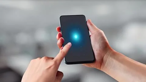 Person using smartphone with glowing blue light on screen Stock Photos
