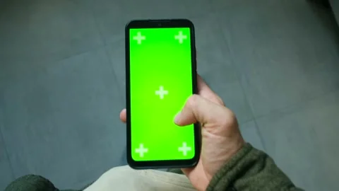 Person using smartphone with green screen and tracking markers Stock Footage 314891203