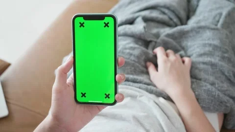 Person Using Smartphone with Green Screen for Customization Stock Footage 315975377