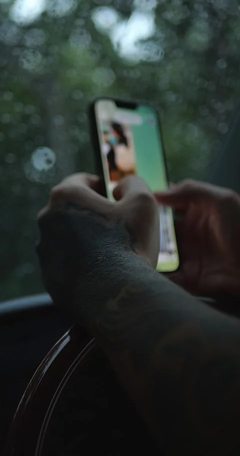 Person Using Smartphone Inside Car During Rain. Illuminated Screen... Stock Footage 332075623