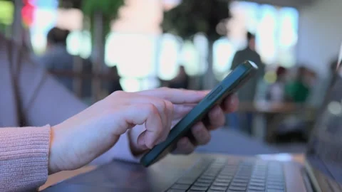 A person is using a smartphone in a modern workspace that promotes productivity Stock Footage 305863774