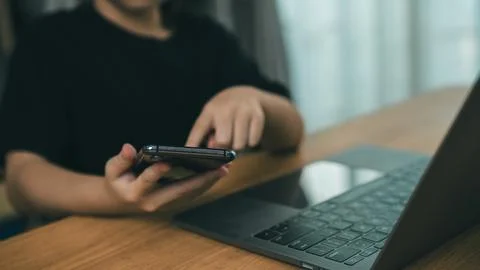 Person using smartphone with one hand and touching screen with finger near .. Stock Photos