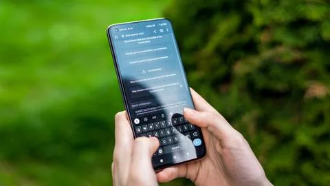 Person using smartphone with opened AI ChatGPT in it 写真素材