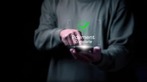 Person using smartphone with payment complete check mark Stock Photos