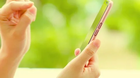 Person using smartphone screen gestures outdoors with blurred green nature Stock-Footage 341802057