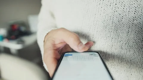 Person using smartphone for typing and texting Stock Footage 318781597