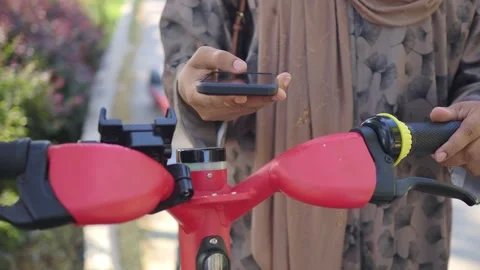 Person Using Smartphone to Unlock Electric Scooter Stock-Footage 341998805