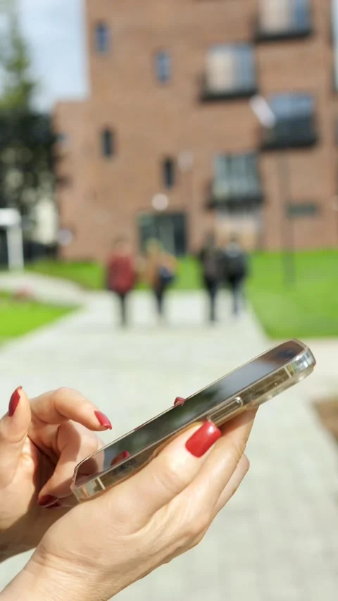 A person is using a smartphone while enjoying the outdoor environment around Stock Footage 285948462