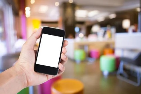Person using smartphone white screen holder on hand with  blurred background  Stock Photos