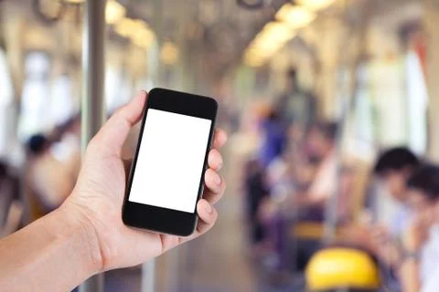 Person using smartphone white screen holder on hand with blurry background of Stock Photos