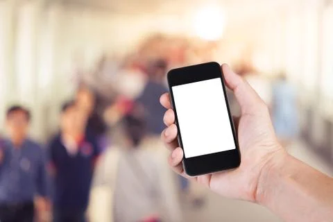Person using smartphone white screen holder on hand with  many people walking Stock Photos