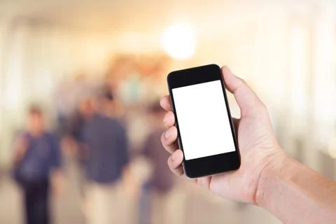 Person using smartphone white screen holder on hand with  many people walking Stock Photos